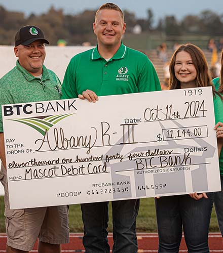 People holding an oversized check from BTC Bank.