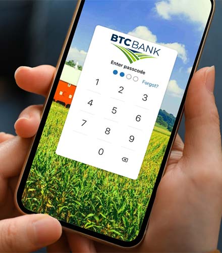 BTC Bank app on a phone in someone's hands.