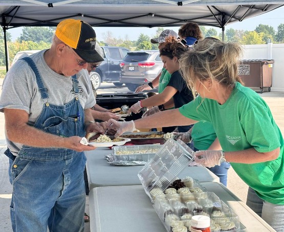 BTC volunteering and serving food at an event