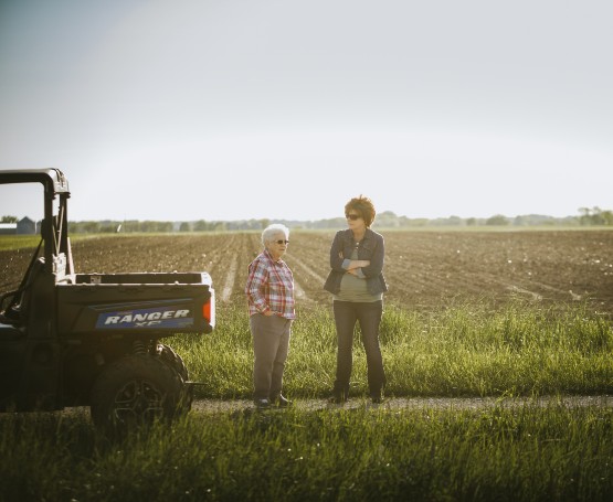 two women standing in a field